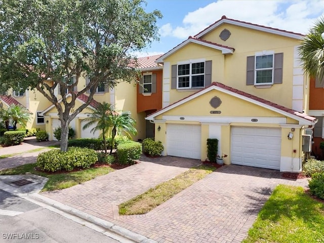 4371 Lazio Way Unit 707, Fort Myers, FL 33901 - view of property featuring stucco siding, driveway, and an attached garage