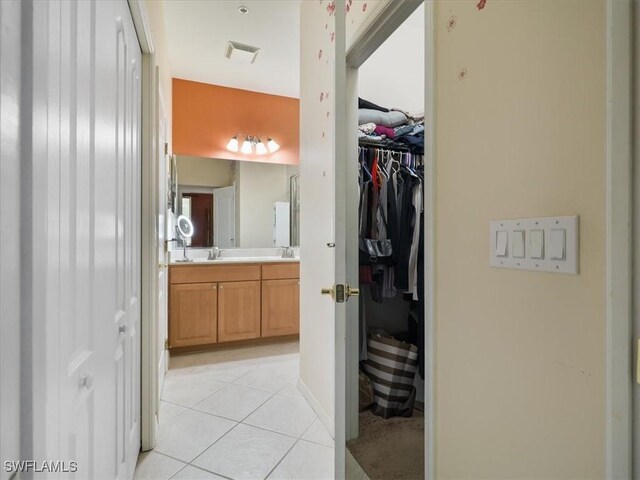 4371 Lazio Way Unit 707, Fort Myers, FL 33901 - bathroom featuring double vanity, visible vents, tile patterned floors, and a spacious closet