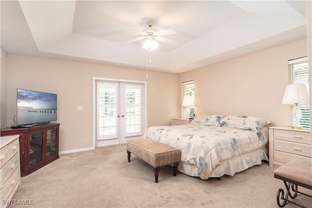 9895 El Greco Cir, Bonita Springs, FL 34135 - bedroom with a raised ceiling, multiple windows, light carpet, and access to exterior