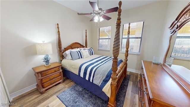 bedroom featuring baseboards, ceiling fan, and light wood finished floors
