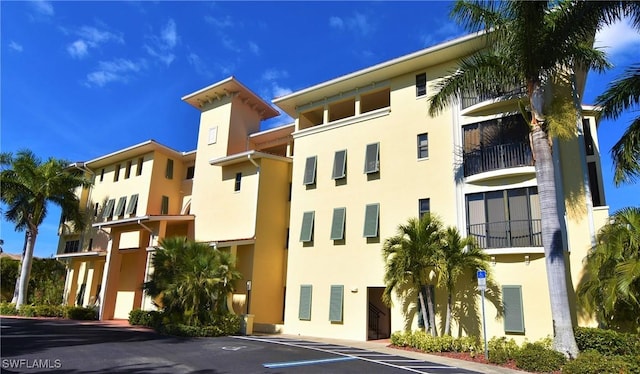 view of property featuring uncovered parking