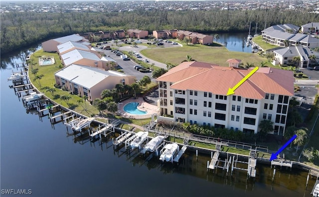 aerial view with a water view and a wooded view