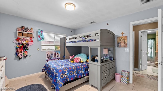 bedroom featuring visible vents, baseboards, and light tile patterned flooring