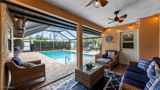 pool with a patio, a ceiling fan, outdoor lounge area, and a lanai