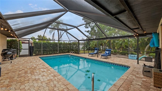 pool featuring area for grilling, a patio area, and glass enclosure