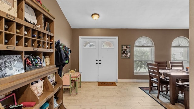entryway with baseboards and light wood-type flooring