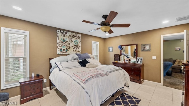 bedroom with ceiling fan, baseboards, visible vents, and light tile patterned floors