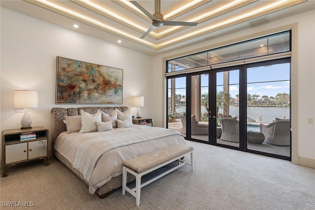 bedroom with a water view, carpet flooring, recessed lighting, and access to exterior