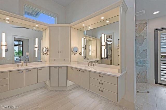full bath with a marble finish shower, a sink, and ensuite bathroom