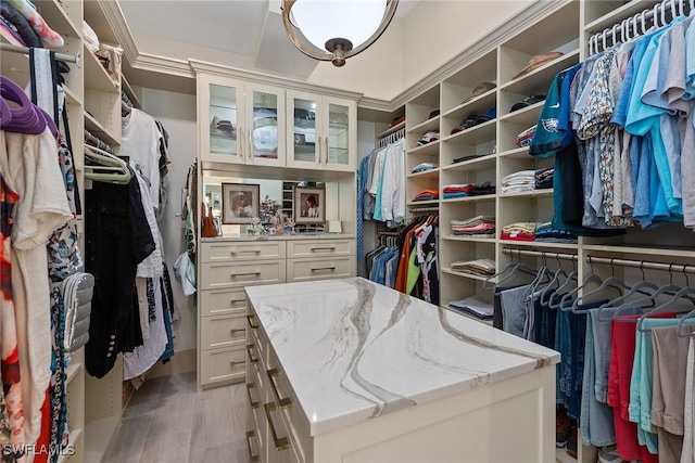 walk in closet with light wood-type flooring