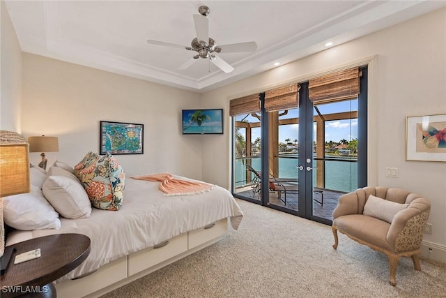 carpeted bedroom featuring recessed lighting, access to exterior, french doors, and a raised ceiling