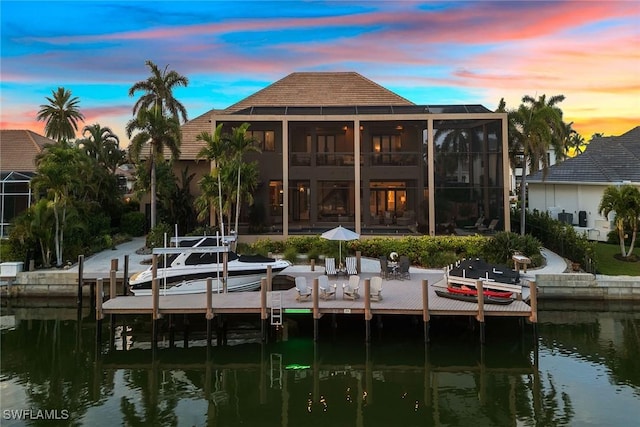 view of dock featuring a patio and a water view