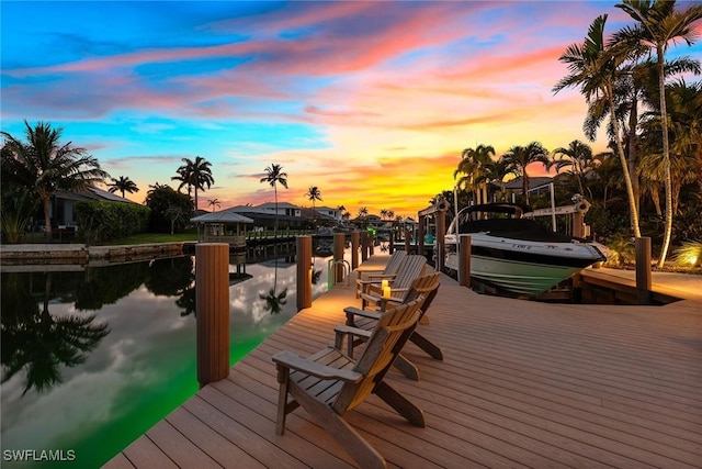 view of dock with boat lift and a water view
