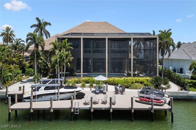 view of dock featuring a water view and a lanai
