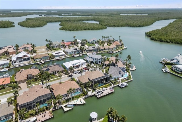 birds eye view of property with a water view, a residential view, and a wooded view