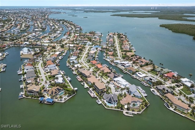 drone / aerial view with a water view and a residential view