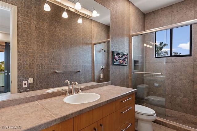 full bathroom featuring vanity, toilet, tile patterned floors, and a stall shower