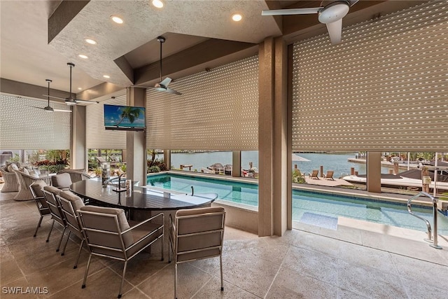 outdoor pool featuring a ceiling fan, a patio area, and exterior bar
