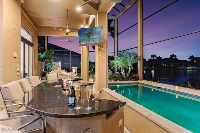 outdoor pool with a patio and a ceiling fan