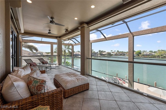sunroom / solarium featuring an outdoor living space, a water view, and ceiling fan