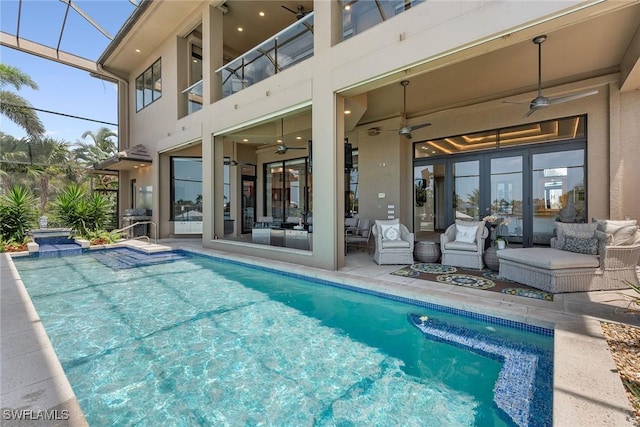 pool featuring an outdoor living space, ceiling fan, and a patio area