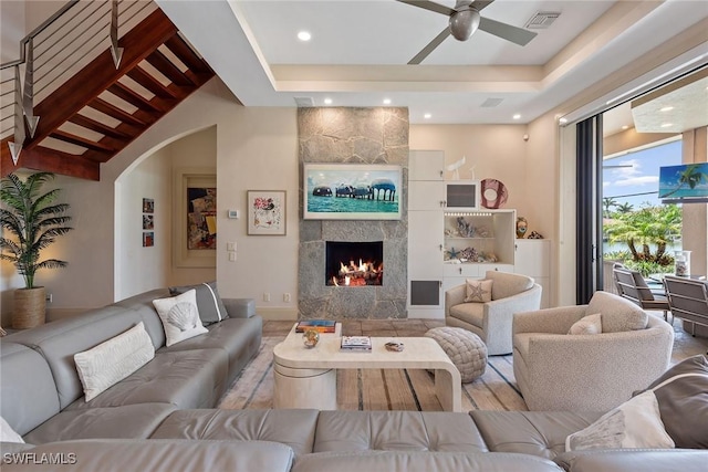 130 Hollyhock Ct, Marco Island, FL 34145 - living room with a fireplace, ceiling fan, arched walkways, and recessed lighting