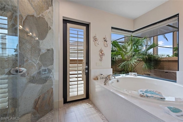 130 Hollyhock Ct, Marco Island, FL 34145 - bathroom featuring a garden tub and a shower stall