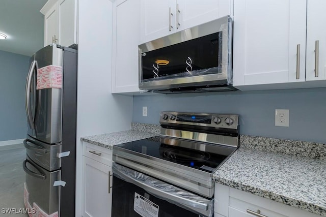 kitchen featuring white cabinetry, appliances with stainless steel finishes, and light stone countertops