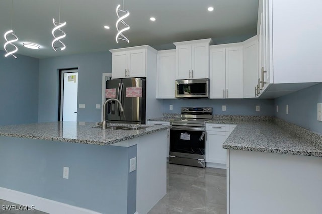kitchen featuring recessed lighting, white cabinetry, light stone counters, a sink, and stainless steel appliances