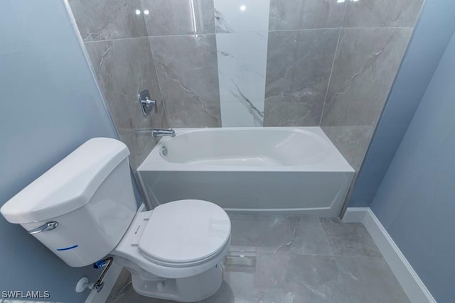 full bath with marble finish floor, bathtub / shower combination, and toilet