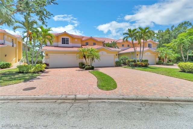 3441 Morning Lake Dr Unit 201, Estero, FL 34134 - mediterranean / spanish house with a tiled roof, decorative driveway, and stucco siding