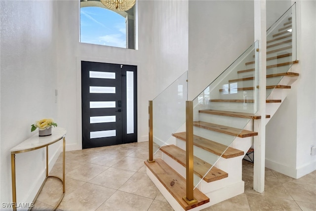 9680 Pineapple Preserve Ct, Fort Myers, FL 33908 - foyer entrance featuring tile patterned floors, stairs, and a towering ceiling
