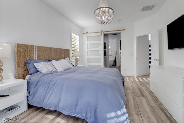 9680 Pineapple Preserve Ct, Fort Myers, FL 33908 - bedroom featuring visible vents, a barn door, an inviting chandelier, and light wood finished floors