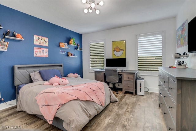 9680 Pineapple Preserve Ct, Fort Myers, FL 33908 - bedroom featuring light wood-type flooring and a chandelier