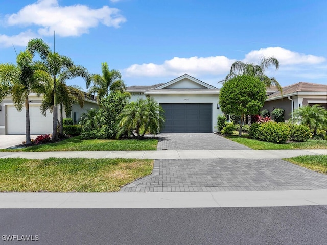 28426 Montecristo Loop, Bonita Springs, FL 34135 - single story home featuring a garage, stucco siding, decorative driveway, and a front yard