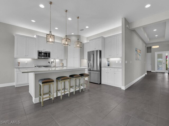28426 Montecristo Loop, Bonita Springs, FL 34135 - kitchen featuring dark tile patterned flooring, light countertops, baseboards, and stainless steel appliances