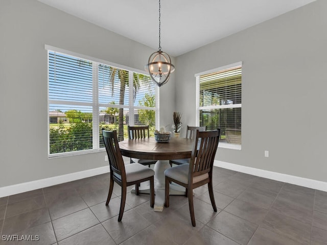 28426 Montecristo Loop, Bonita Springs, FL 34135 - dining space with an inviting chandelier, baseboards, and dark tile patterned floors