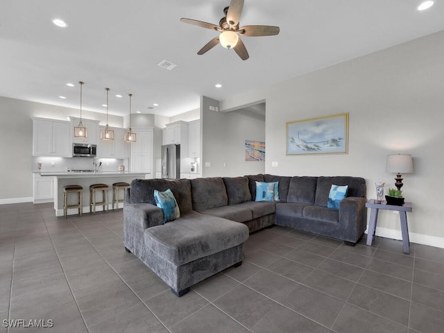 28426 Montecristo Loop, Bonita Springs, FL 34135 - living room featuring dark tile patterned flooring, a ceiling fan, baseboards, and visible vents