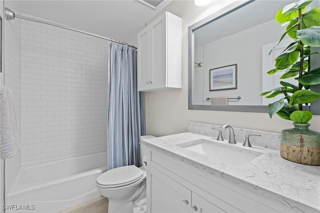 full bathroom with toilet, vanity, and shower / bath combo with shower curtain