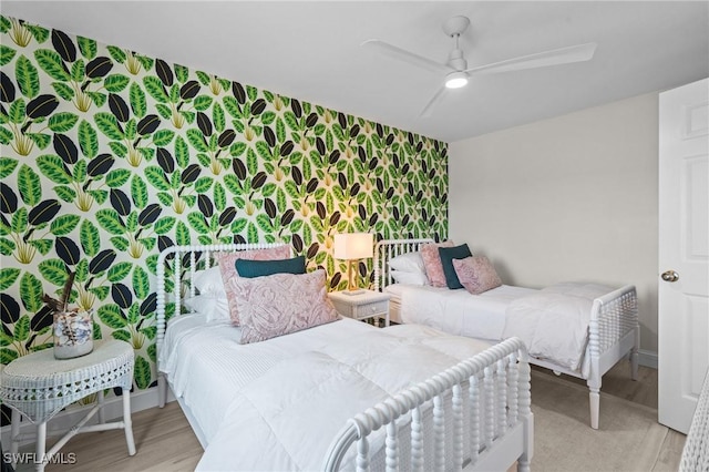 bedroom featuring wood finished floors and a ceiling fan