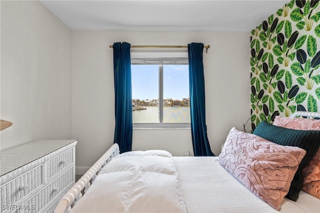 bedroom featuring a water view