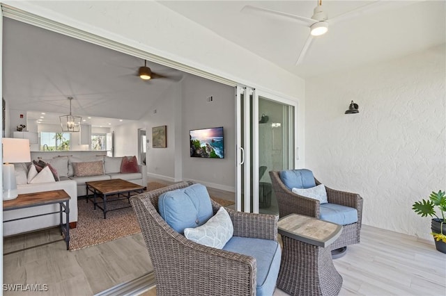 deck with ceiling fan and an outdoor living space