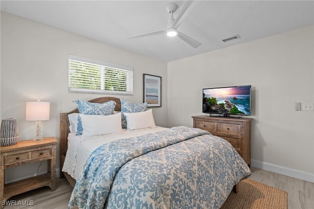 bedroom with wood finished floors, ceiling fan, and baseboards