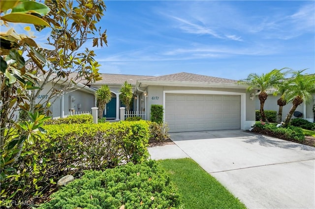 6171 Mandalay Cir Unit 28, Naples, FL 34112 - single story home with an attached garage, a shingled roof, stucco siding, and concrete driveway