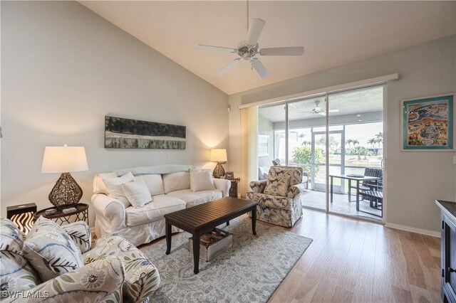 6171 Mandalay Cir Unit 28, Naples, FL 34112 - living room with baseboards, a ceiling fan, light wood finished floors, and vaulted ceiling
