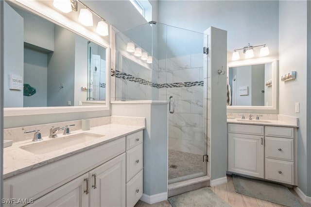 6171 Mandalay Cir Unit 28, Naples, FL 34112 - full bathroom featuring baseboards, a sink, two vanities, and a shower stall