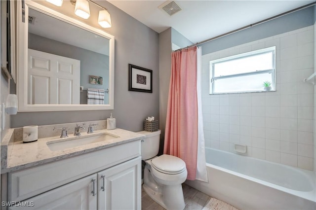 6171 Mandalay Cir Unit 28, Naples, FL 34112 - full bathroom featuring visible vents, shower / tub combo with curtain, toilet, and vanity