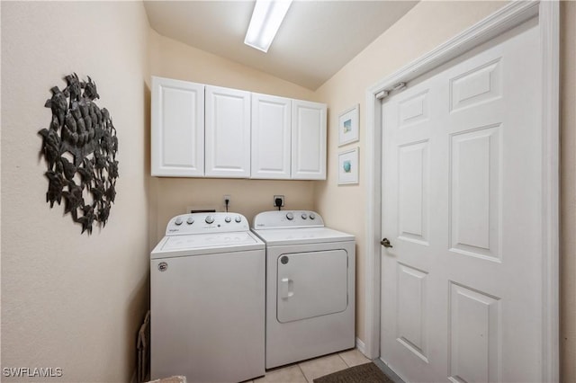 6171 Mandalay Cir Unit 28, Naples, FL 34112 - clothes washing area featuring washer and clothes dryer, cabinet space, and light tile patterned floors