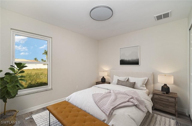 2727 SW 18th Pl, Cape Coral, FL 33914 - bedroom with baseboards, visible vents, and wood finished floors