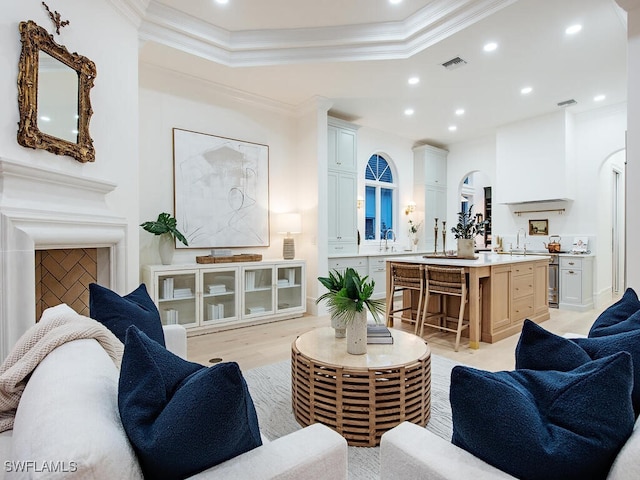 650 Bow Line Dr, Naples, FL 34103 - living room with crown molding, recessed lighting, light wood-type flooring, and arched walkways